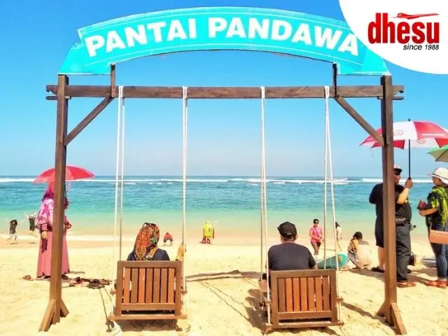 Beach swings and parasols set out on the sand at Pantai Pandawa in southern Bali