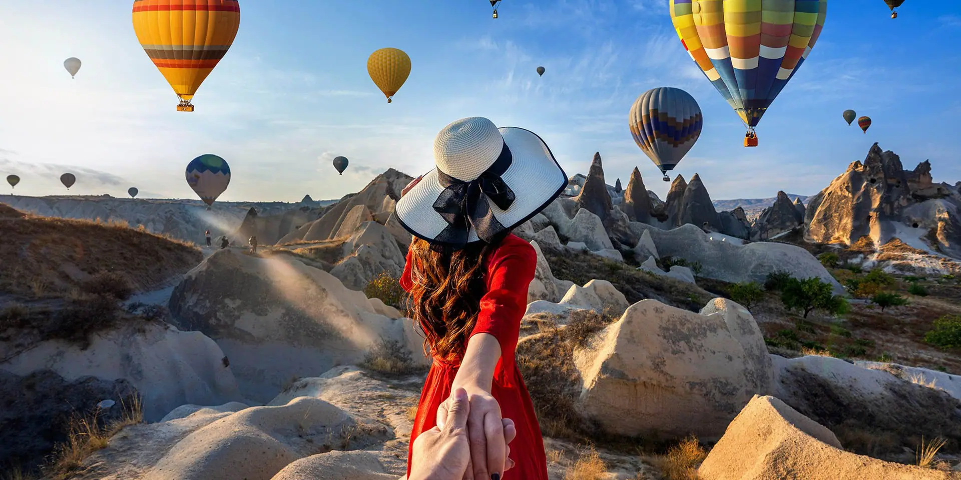 Hot-air balloons rising over the rock formations of Cappadocia, Turkey