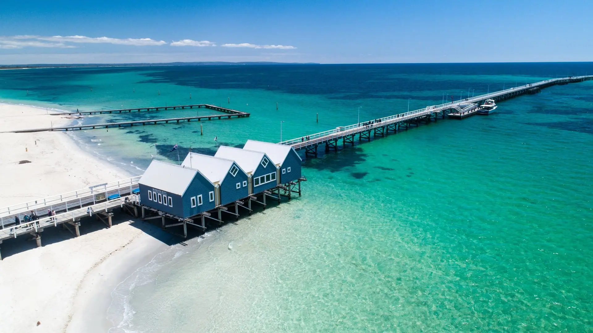 The long timber Busselton Jetty stretching over turquoise water in Western Australia