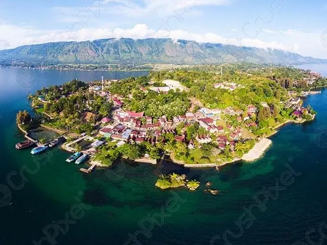 An aerial view of an island town surrounded by lake water