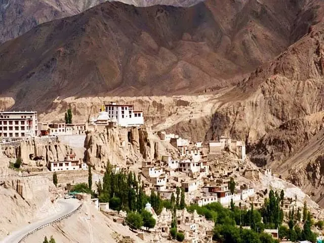 A monastery built into a bare Himalayan mountainside