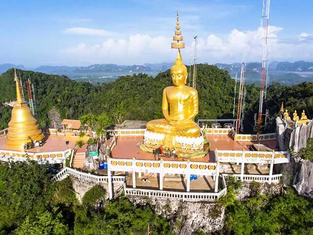 The gilded Buddha and mountaintop shrine at Tiger Cave Temple, Krabi