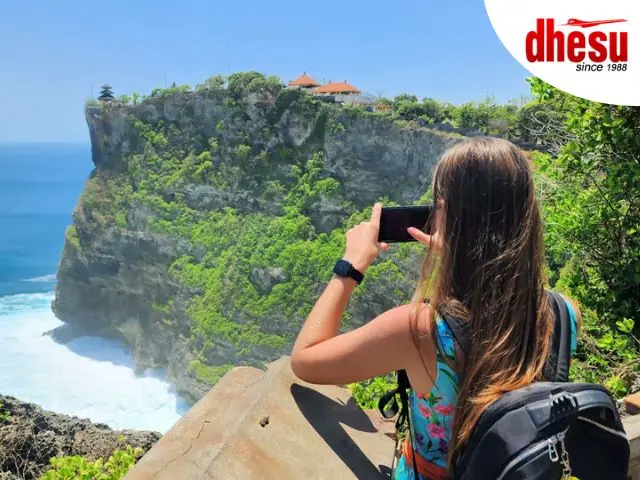 Uluwatu cliff temple above the Indian Ocean with dramatic sunset sky, Bali