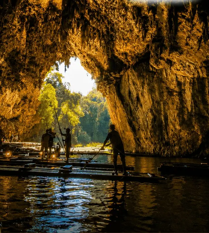 Bamboo rafts on the water inside Tham Lod Cave