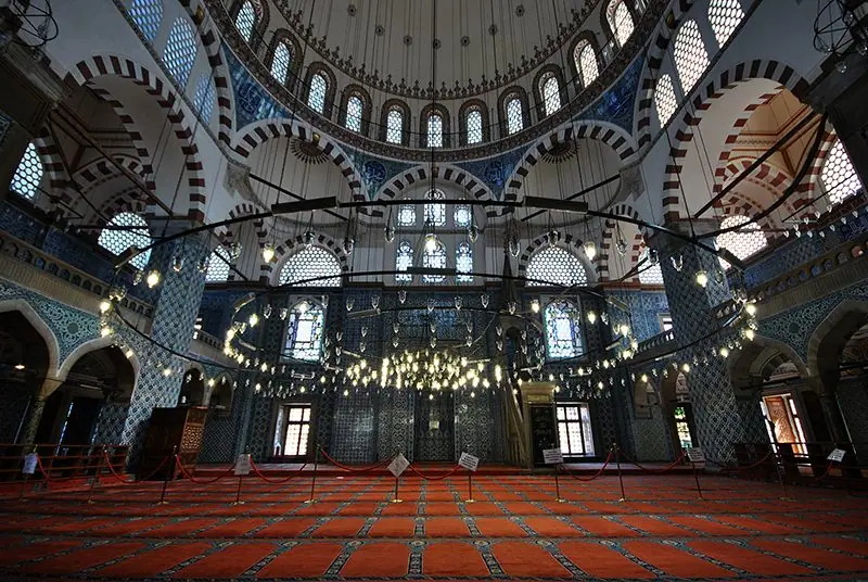 The tiled interior and prayer carpet of an Ottoman mosque