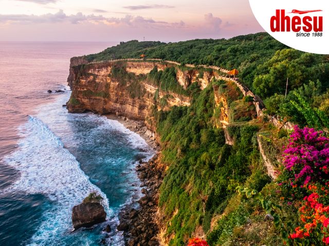 Uluwatu Temple on the edge of a high sea cliff above the Indian Ocean at sunset, Bali