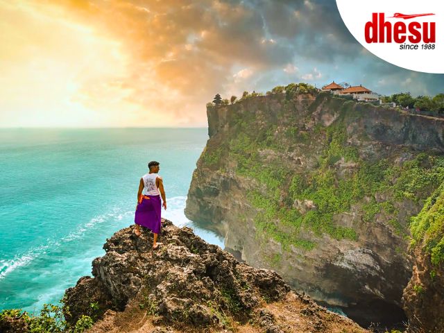 Uluwatu Temple on the cliff edge with panoramic Indian Ocean views at sunset, Bali